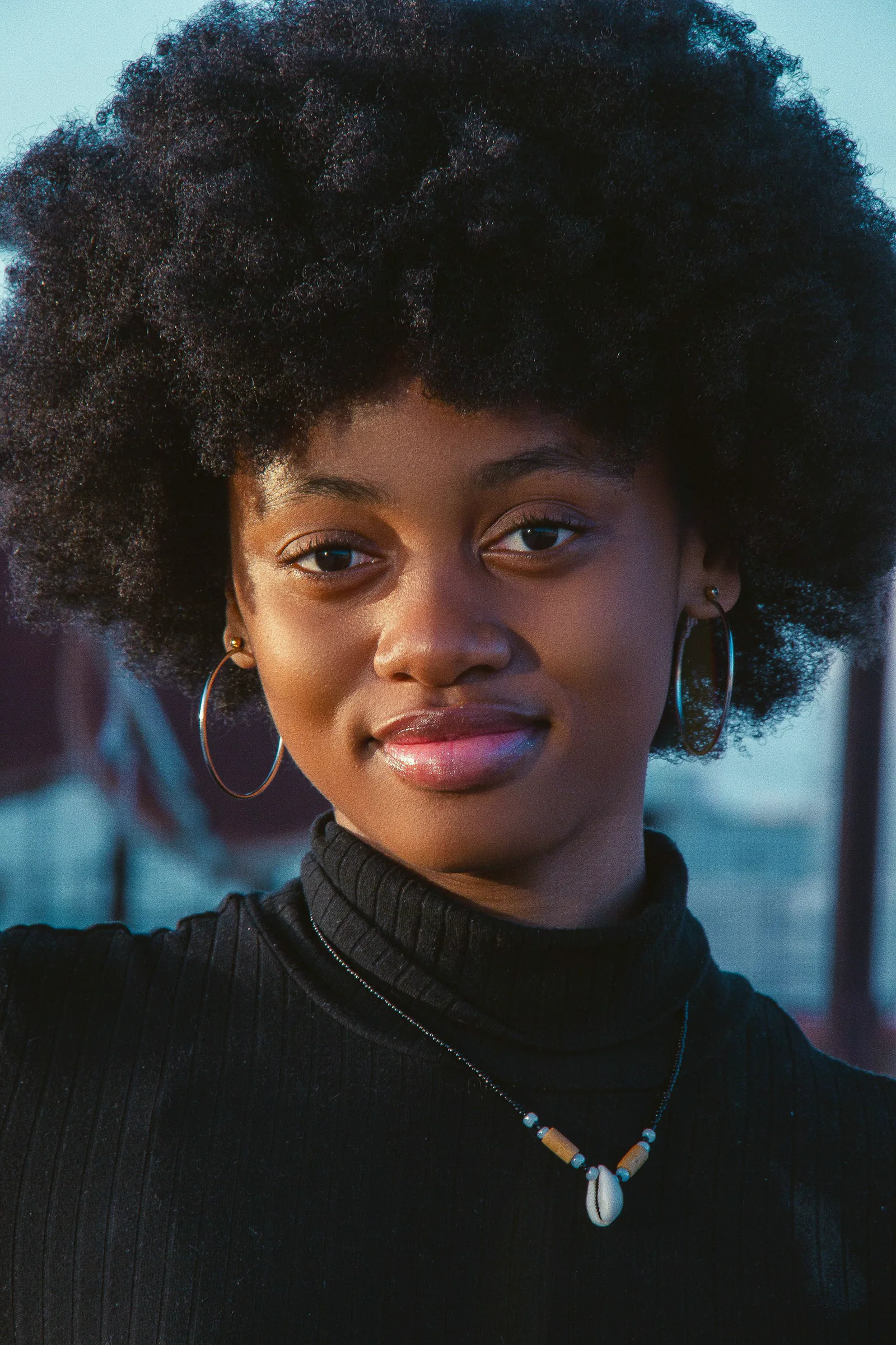 A full natural afro, smiling