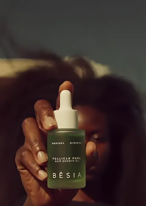 The Follicle Fuel bottle rises through flying hair